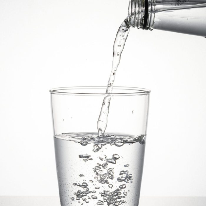 macro-shot-water-pouring-into-glass-min